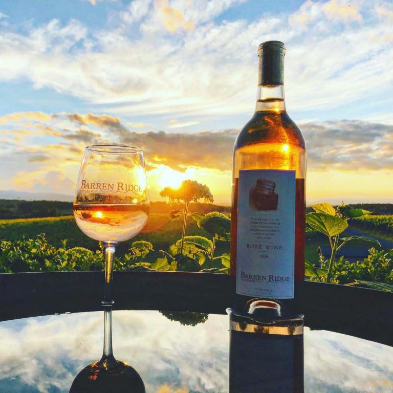 An image showing a Rosé Wine from Barren Ridge with a sunset in the background.